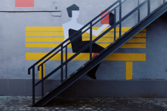 black-metal-staircase-next-to-a-drawn-gray-concrete-floor-3964743-scaled