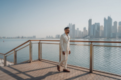 walking-man-wearing-white-suit-beside-fence-3109603-scaled