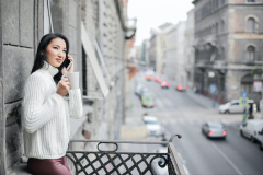 woman-in-white-sweater-standing-on-balcony-3764186-scaled